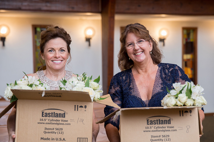 The mother of the bride and mother of the groom hold wedding flowers before the Sept. 15 nuptials of their children in Durham at Holy Infant Church.