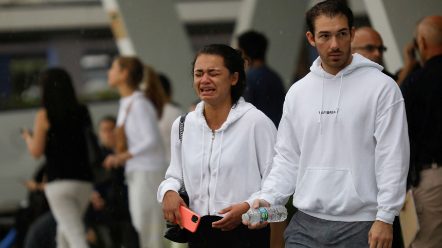 A woman weeps at the Surfside Community Center where authorities took residents and relatives from a partially collapsed building in Surfside, Fla., just north of Miami Beach June 24, 2021. (CNS photo/Marco Bello, Reuters)