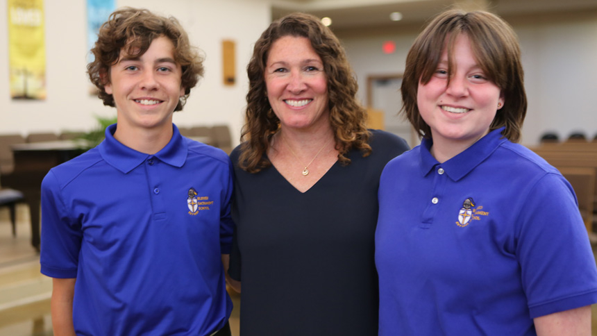 Kelley Champion smiles with two of her middle school students, Timothy Klein (left) and Avery LaPlante.