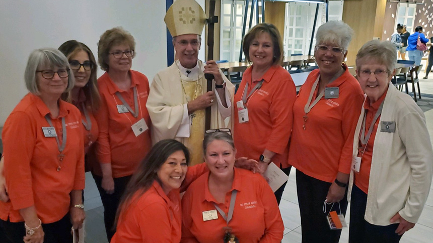 Standing, from left: FS Patti Dmuchowski, Treasurer Jen Parsons, Secretary Kathy Thomas, Bishop Luis, State President Maggie Herbstritt, Advocate Maggie Muelker, Immed and (kneeling, from left) PP Ginny Grant, Sentinel Marg Young, VP Teresa Laraia