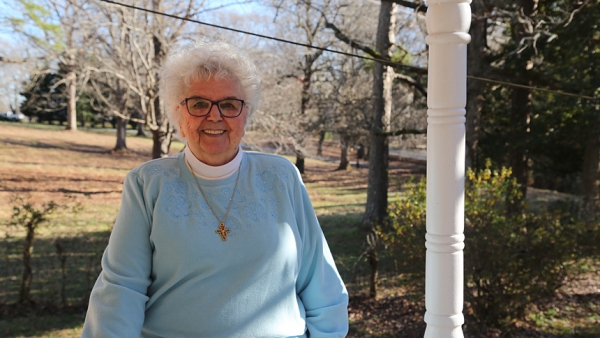 Sister Damian Jackson, O.S.F., 87, stands on the porch of her Durham home near Avila Retreat Center, where she served as director for three decades. This year Sister Damian celebrates her 65th jubilee.