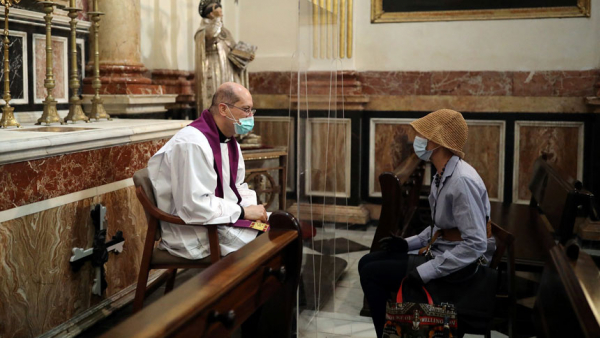 A priest hears confession inside the cathedral in Valencia, Spain, May 19, 2020, amid the coronavirus pandemic. For the Christian, fasting during Lent is ultimately about fasting from sin. (CNS photo/Nacho Doce, Reuters)